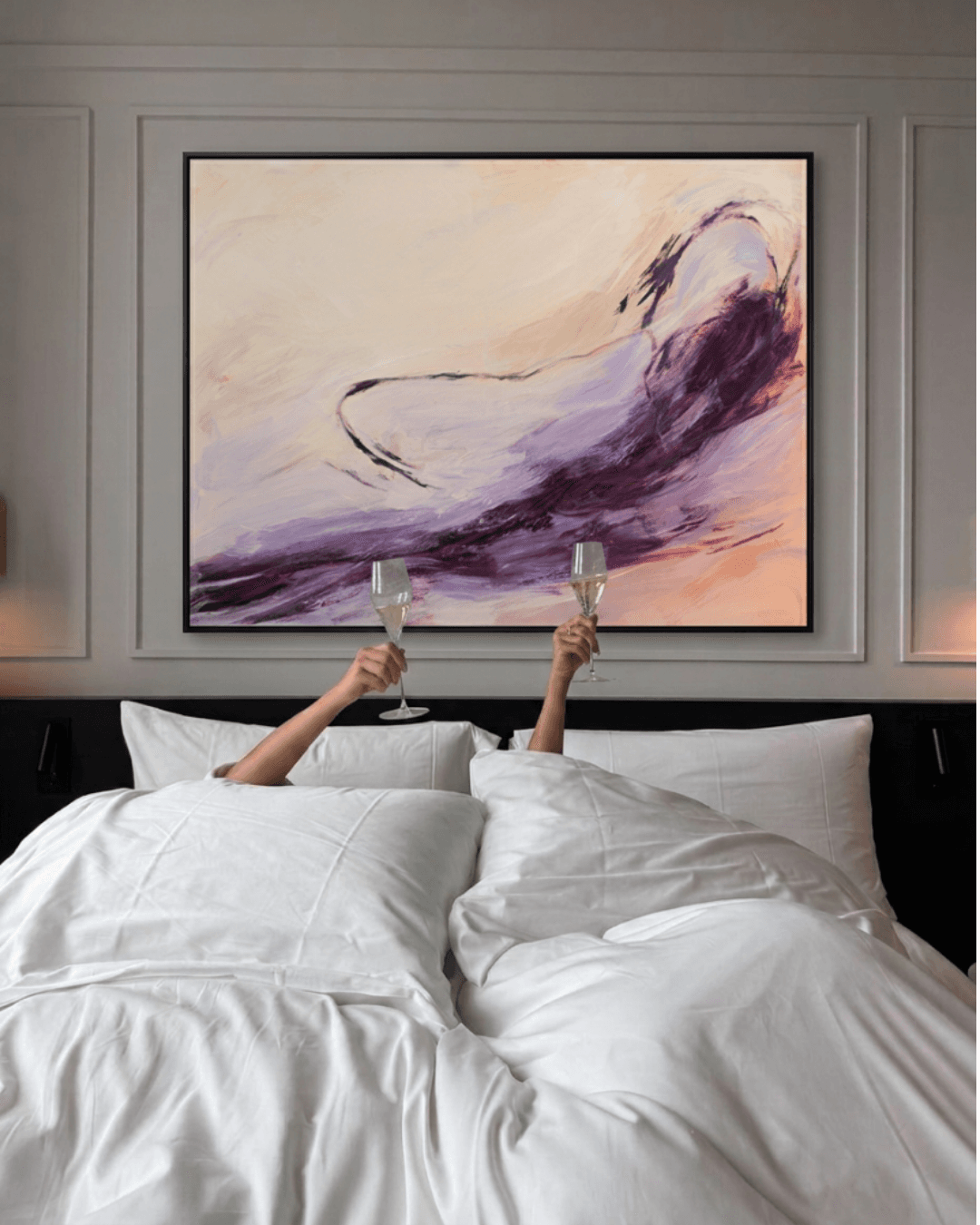 An original abstract painting installed above a hotel bed